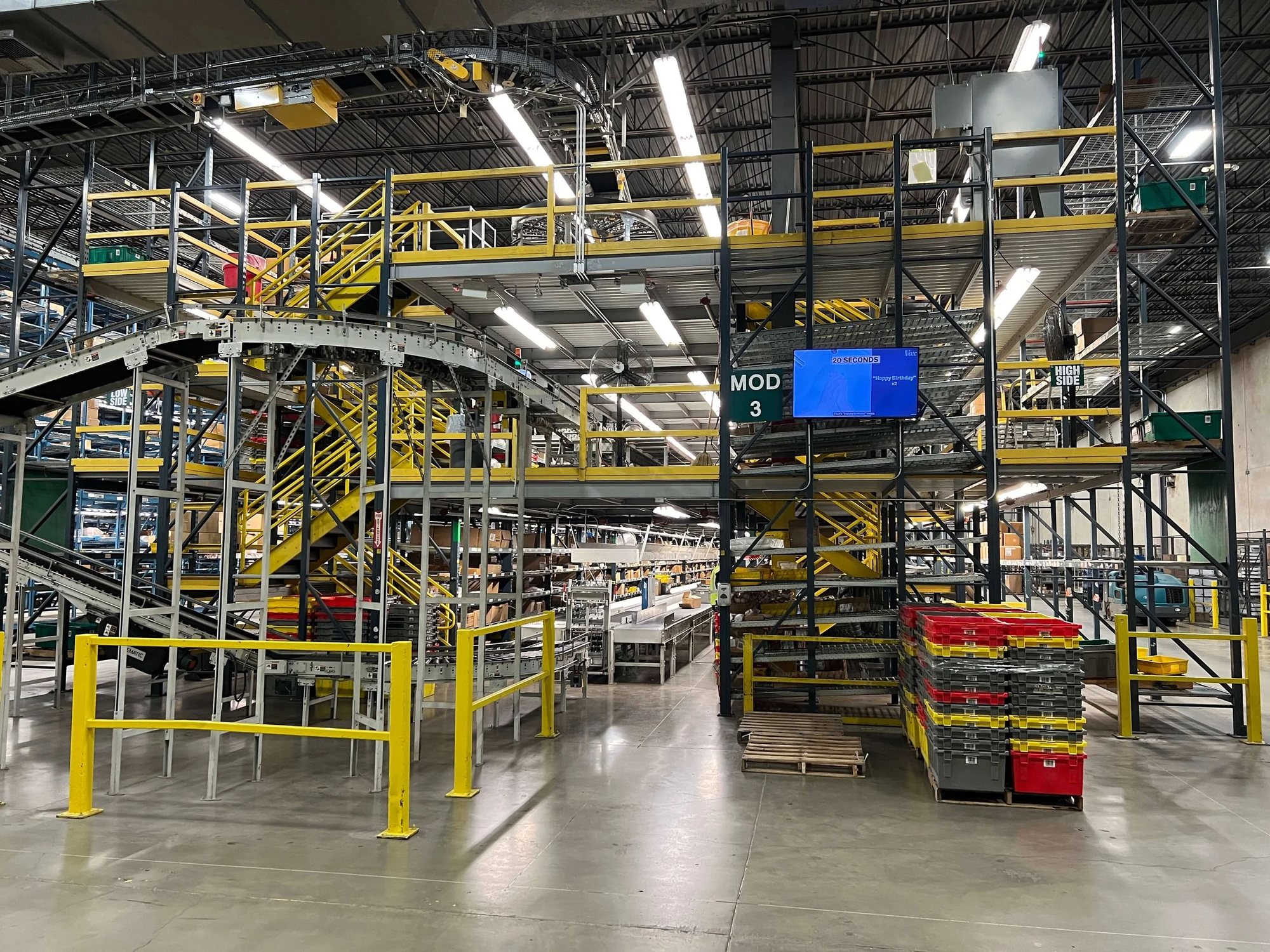Multi-level pick module and conveyor system inside a warehouse